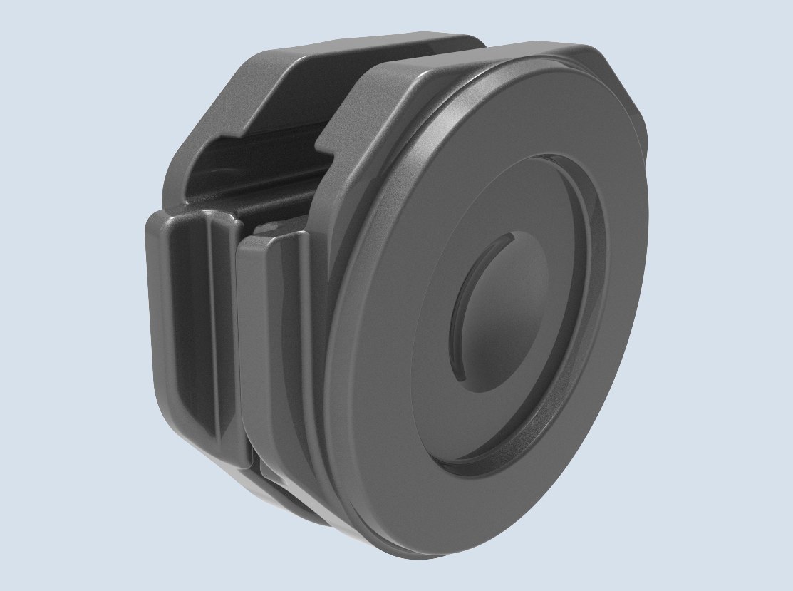 Un objet rond, gris foncé, semblable à un aimant, avec une surface texturée et rainurée, se détache sur un fond bleu clair. L'objet présente un cercle central surélevé et une encoche latérale, ce qui lui donne une apparence mécanique.